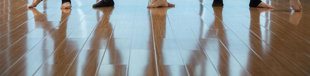 wooden floor reflection of people standing